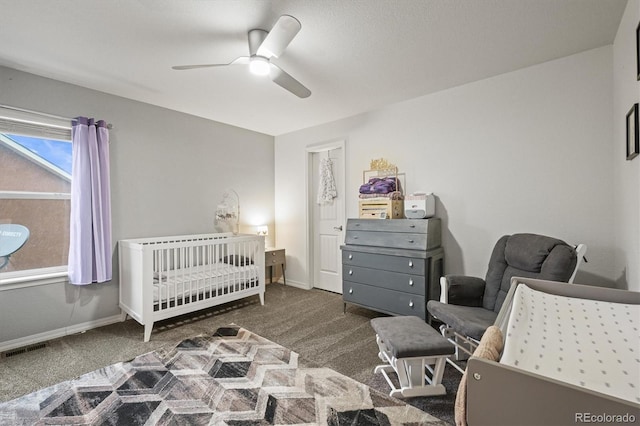 3677 Reindeer Cir, Colorado Springs, CO 80922 - bedroom with carpet, a crib, ceiling fan, and baseboards