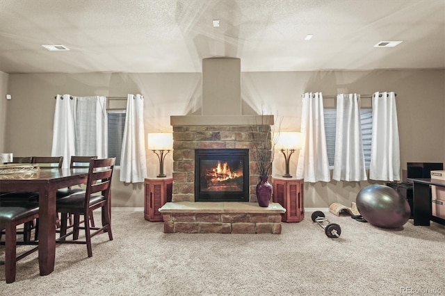3677 Reindeer Cir, Colorado Springs, CO 80922 - living area featuring carpet flooring, a stone fireplace, baseboards, and a textured ceiling