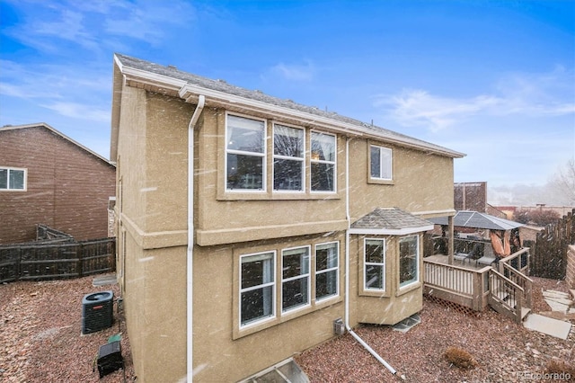 3677 Reindeer Cir, Colorado Springs, CO 80922 - back of house featuring stucco siding, a gazebo, central AC, and a wooden deck
