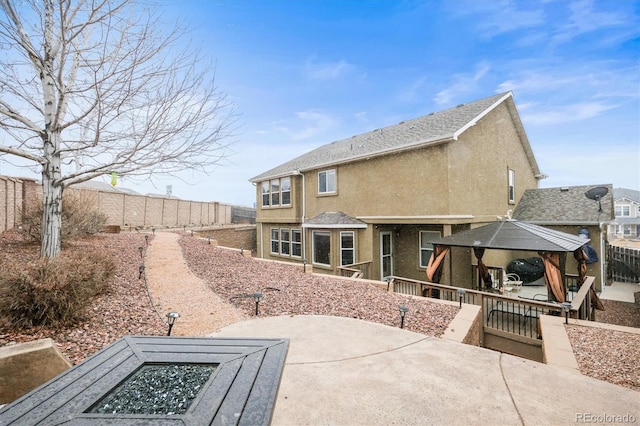 3677 Reindeer Cir, Colorado Springs, CO 80922 - back of house featuring a gazebo, a patio area, a fenced backyard, and stucco siding