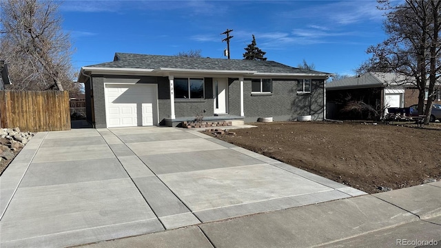 single story home with a garage, driveway, fence, and brick siding