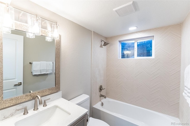 bathroom featuring a textured wall, toilet, vanity, visible vents, and  shower combination