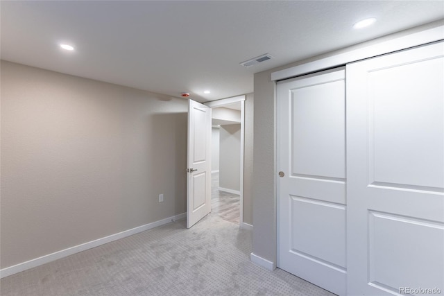 unfurnished bedroom featuring recessed lighting, light colored carpet, visible vents, and baseboards