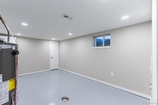 below grade area with recessed lighting, gas water heater, visible vents, and baseboards