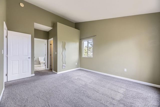 7415 S Alkire St Unit 302, Littleton, CO 80127 - unfurnished bedroom featuring lofted ceiling, carpet floors, baseboards, and connected bathroom