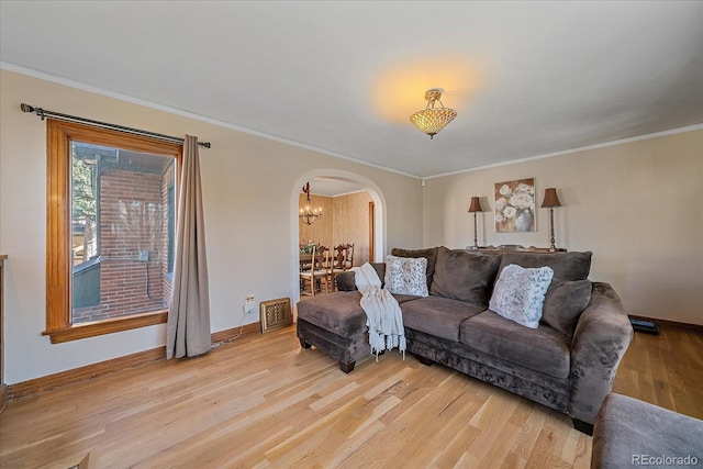 living room with light hardwood / wood-style flooring and ornamental molding