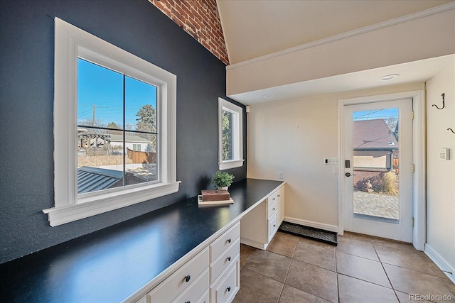 doorway to outside with light tile patterned floors