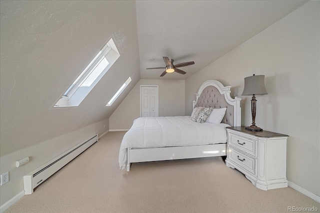 bedroom featuring a closet, vaulted ceiling, baseboard heating, and ceiling fan