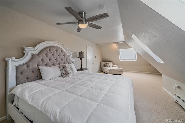 bedroom featuring carpet, ceiling fan, a baseboard heating unit, and vaulted ceiling with skylight