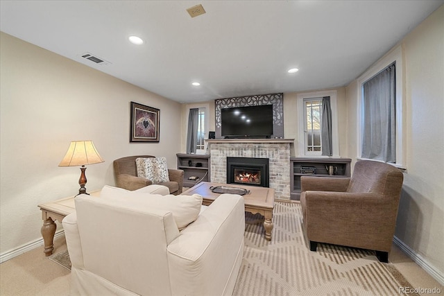 carpeted living room with a brick fireplace