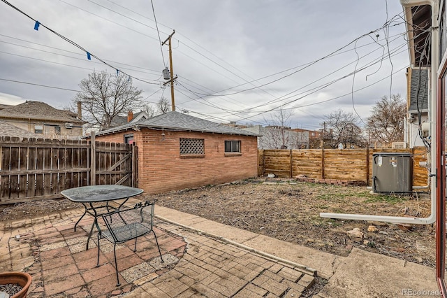 view of patio with an outbuilding and a fenced backyard