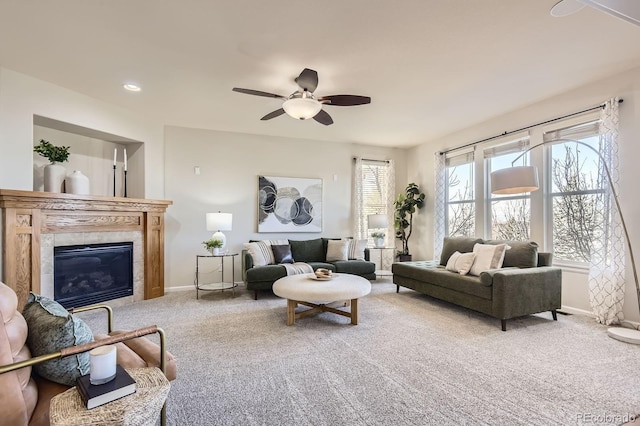 carpeted living area featuring a tiled fireplace, recessed lighting, baseboards, and a ceiling fan