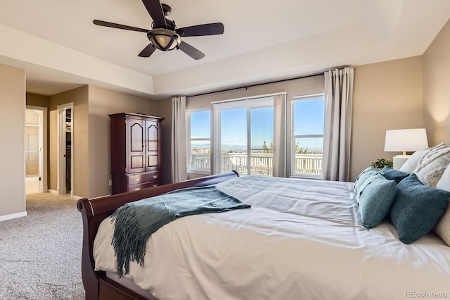 bedroom with a ceiling fan, baseboards, access to exterior, a spacious closet, and carpet flooring