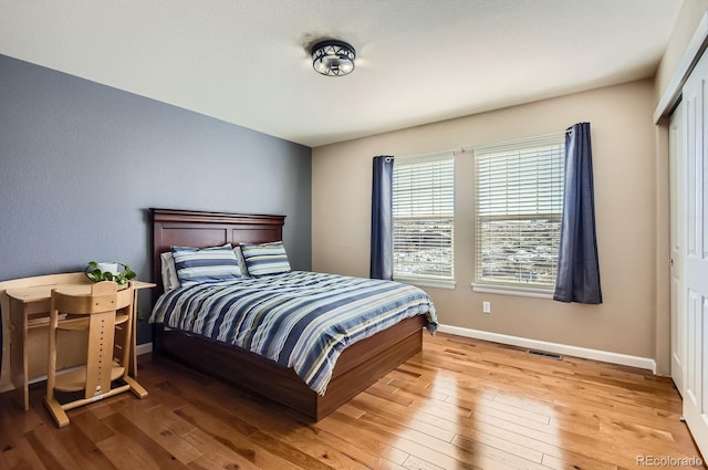 bedroom featuring visible vents, baseboards, and light wood-style flooring