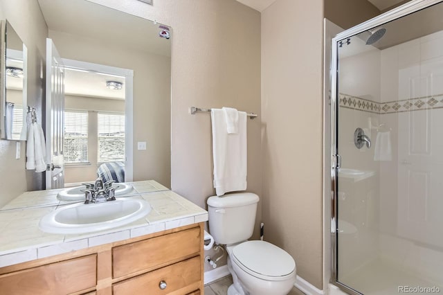 full bath featuring a stall shower, toilet, and vanity