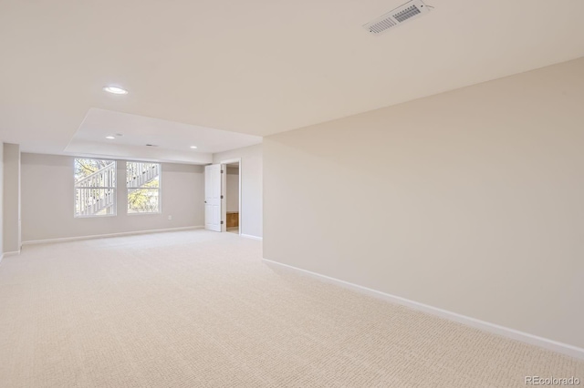 spare room with recessed lighting, light colored carpet, visible vents, and baseboards