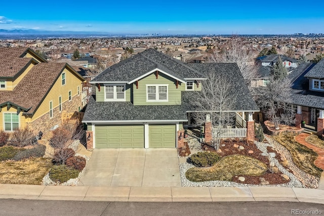 view of front of house featuring driveway, a residential view, roof with shingles, a garage, and brick siding