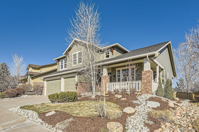 craftsman-style home featuring a garage, a porch, and driveway