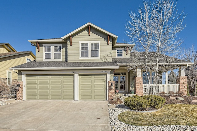 view of front of property with concrete driveway, an attached garage, brick siding, and a shingled roof