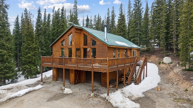 585 Miners Way, Fairplay, CO 80440 - rear view of property featuring a wooden deck, a garage, driveway, faux log siding, and stairway