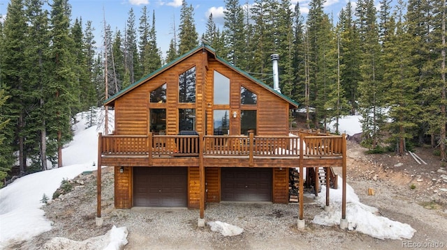 585 Miners Way, Fairplay, CO 80440 - view of front of home featuring log veneer siding, a garage, driveway, and a deck