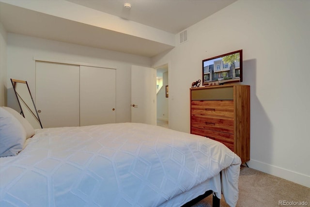 bedroom featuring light carpet and a closet