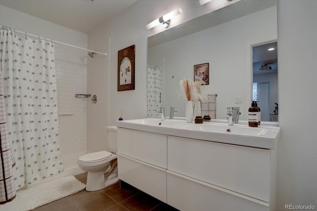 bathroom with a shower with shower curtain, vanity, toilet, and tile patterned floors