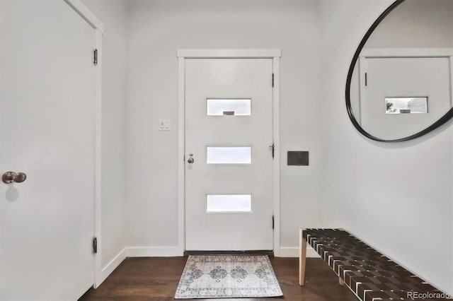 foyer entrance featuring baseboards and dark wood-type flooring