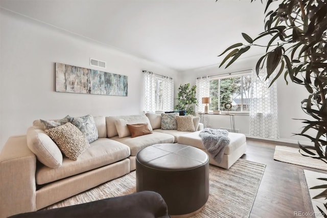 living area featuring wood finished floors and visible vents