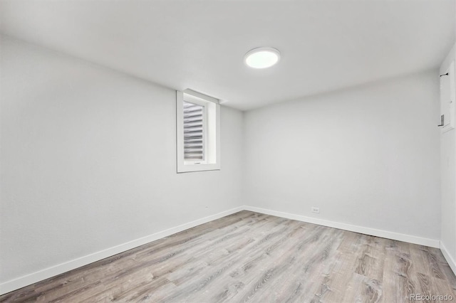 empty room with baseboards and wood finished floors