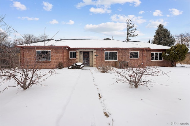 ranch-style house featuring brick siding