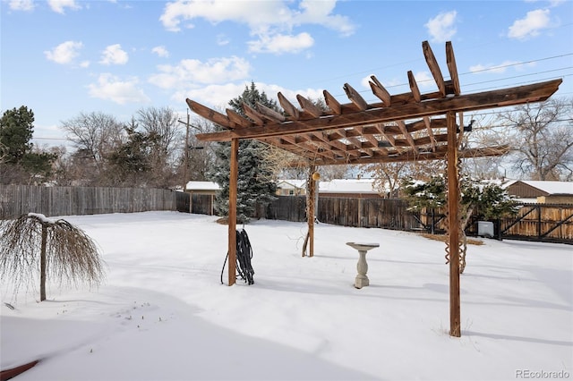 yard covered in snow with a fenced backyard and a pergola