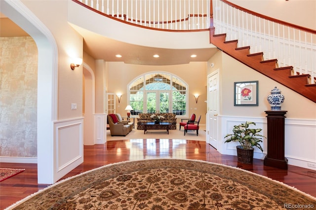 foyer with a high ceiling and dark hardwood / wood-style floors