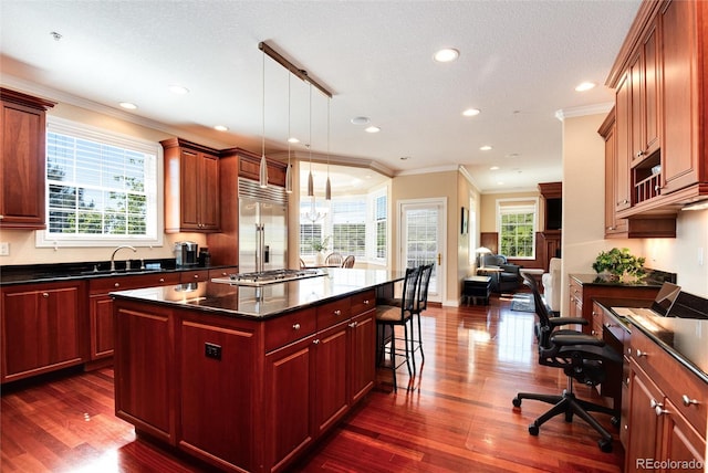 kitchen featuring stainless steel appliances, dark wood-type flooring, pendant lighting, and a center island