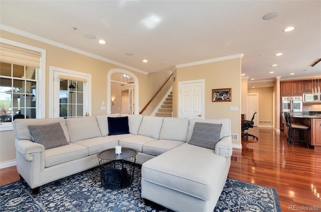 living room with wood-type flooring and crown molding