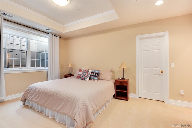 carpeted bedroom with a raised ceiling and crown molding