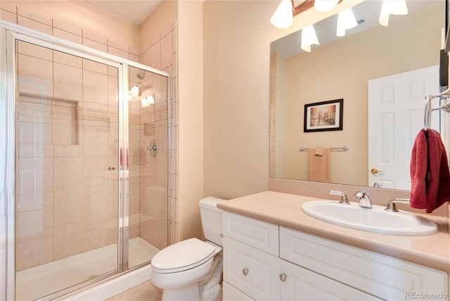 bathroom with toilet, vanity, and walk in shower