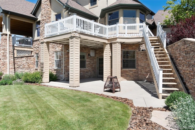 rear view of house with a deck, a yard, and a patio