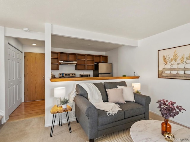 living room featuring light carpet, baseboards, and beam ceiling
