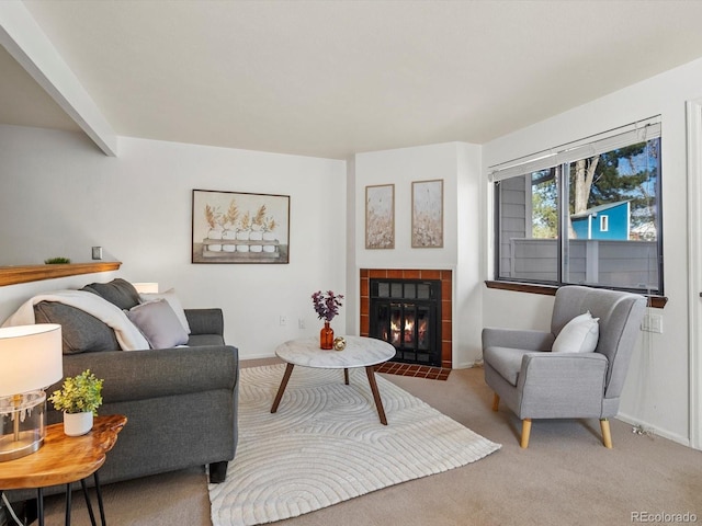 carpeted living area featuring baseboards, a tile fireplace, and beamed ceiling
