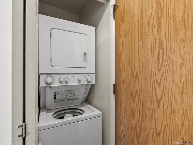 laundry area with stacked washer / dryer and laundry area