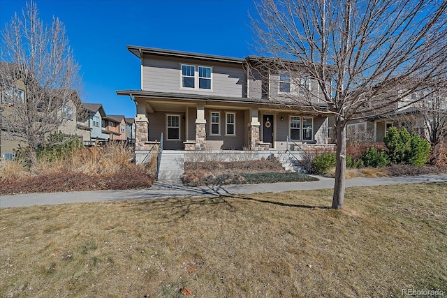 view of front of property with stone siding, a porch, and a front yard