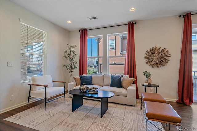 interior space with a wealth of natural light, light wood-style flooring, visible vents, and baseboards