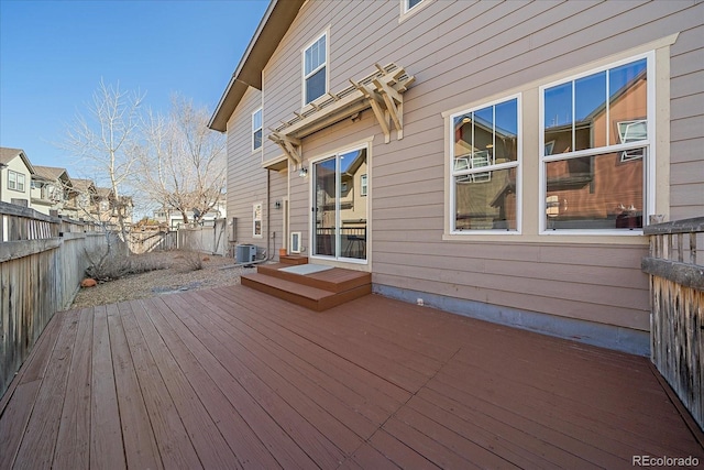 deck featuring cooling unit, a residential view, and fence private yard