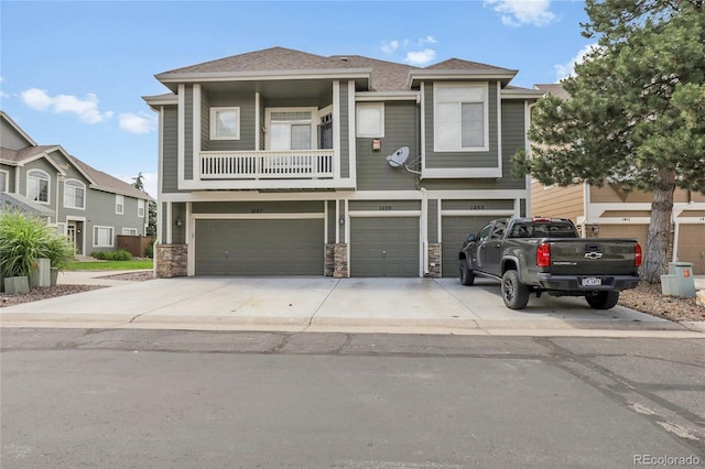 1409 Carlyle Park Cir, Highlands Ranch, CO 80129 - view of front of home featuring an attached garage, driveway, stone siding, a balcony, and roof with shingles