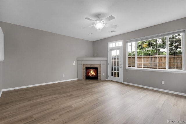 1409 Carlyle Park Cir, Highlands Ranch, CO 80129 - unfurnished living room featuring wood finished floors, a ceiling fan, and a fireplace