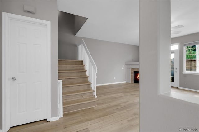 1409 Carlyle Park Cir, Highlands Ranch, CO 80129 - stairs with wood finished floors, a brick fireplace, and ceiling fan