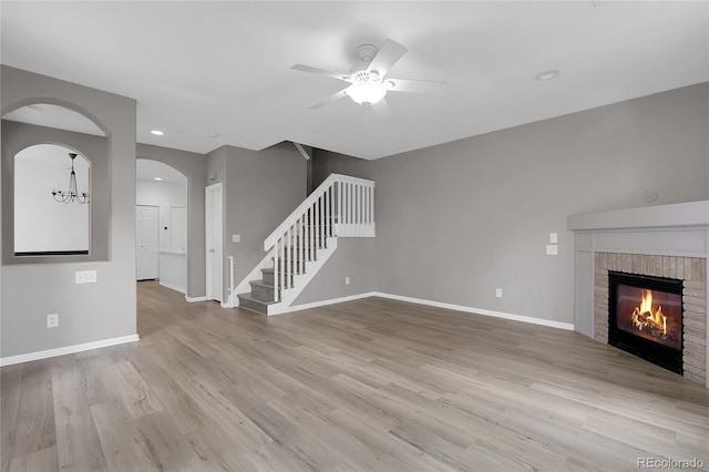 1409 Carlyle Park Cir, Highlands Ranch, CO 80129 - unfurnished living room with a ceiling fan, stairway, wood finished floors, a fireplace, and recessed lighting
