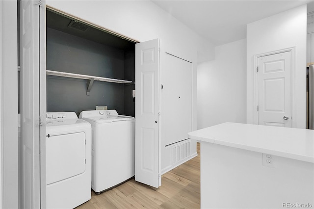 1409 Carlyle Park Cir, Highlands Ranch, CO 80129 - laundry area featuring light wood-style floors and washer and dryer