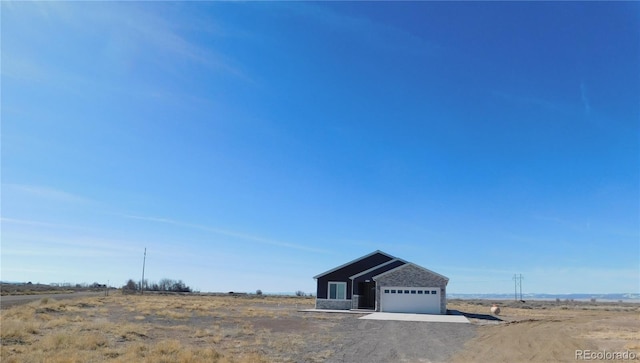 view of front facade featuring a garage and an outbuilding